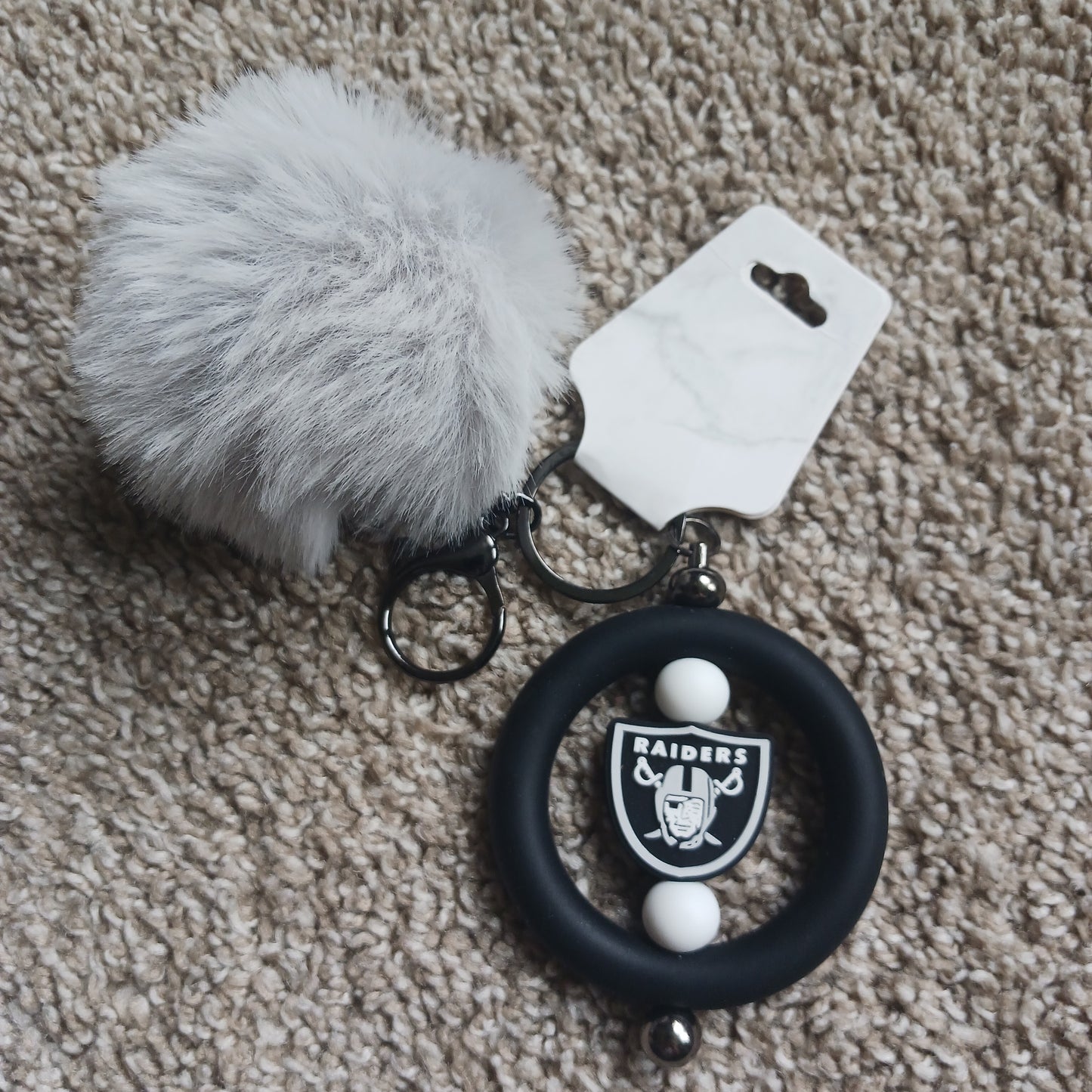 Team Raid keychain with pom-pom