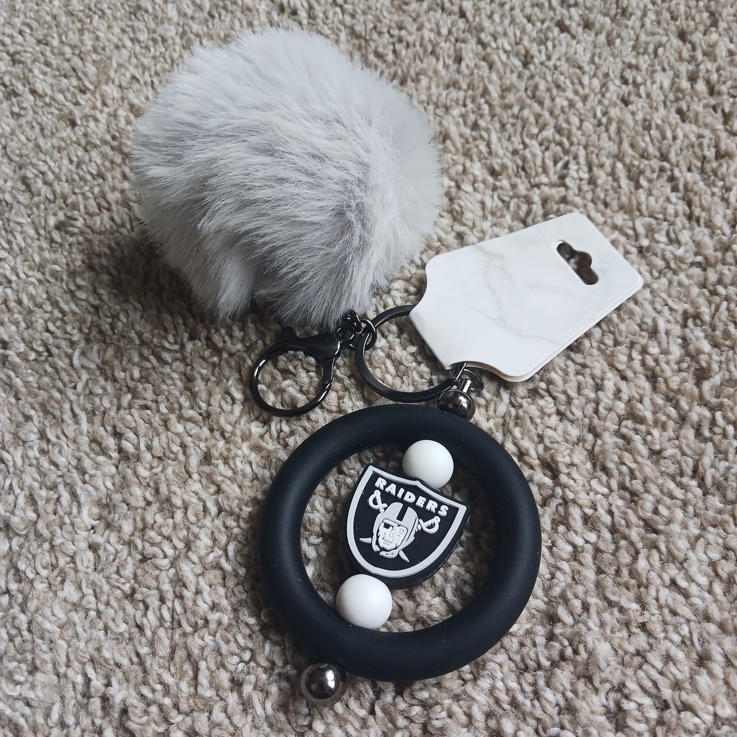 Team Raid keychain with pom-pom