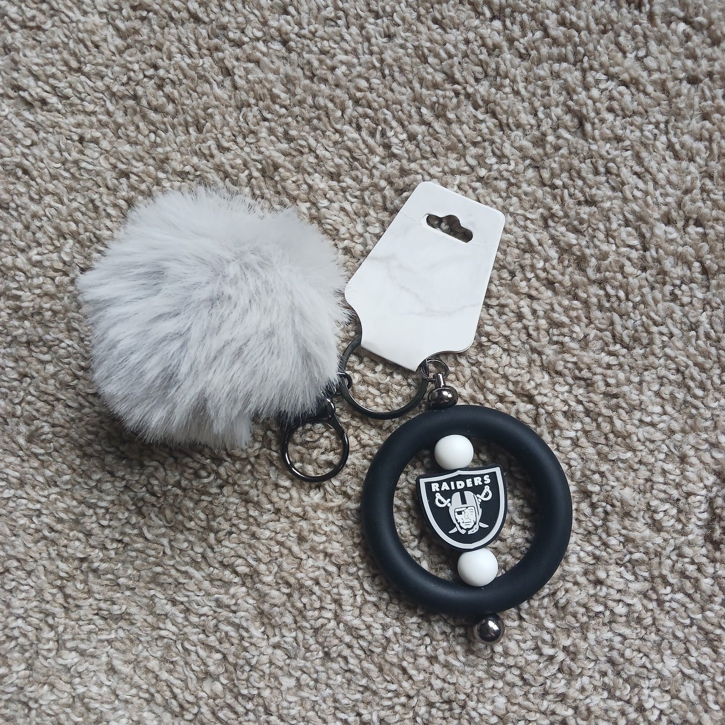 Team Raid keychain with pom-pom