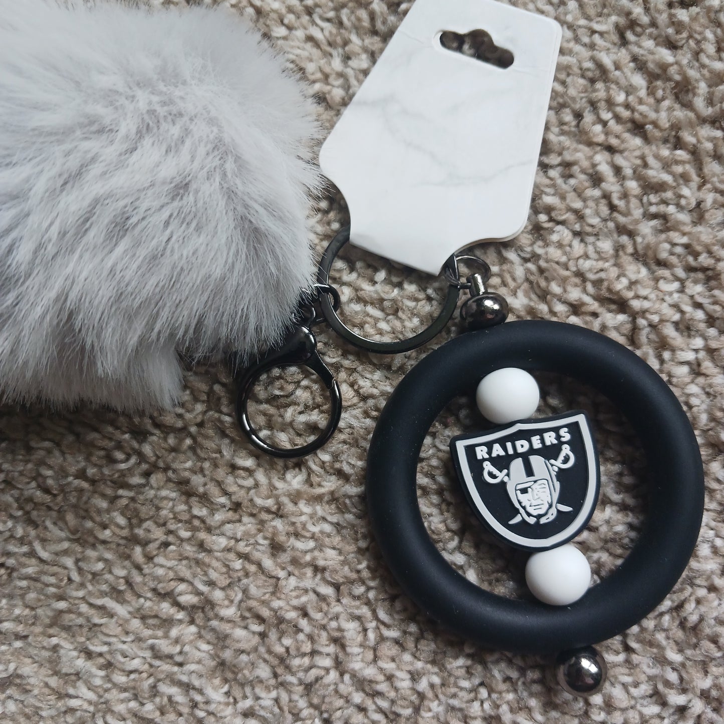 Team Raid keychain with pom-pom