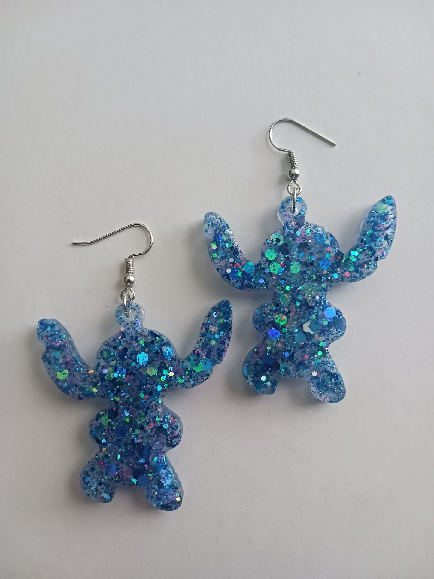 Large fun blue alien shaped earrings