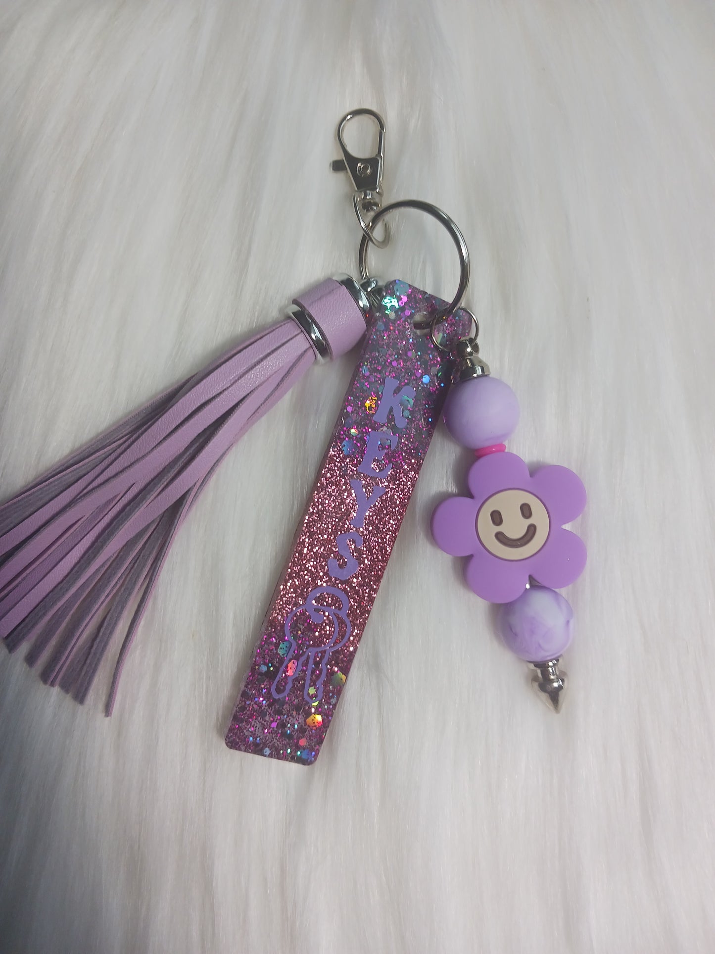 Purple flower keychain bar with tassel