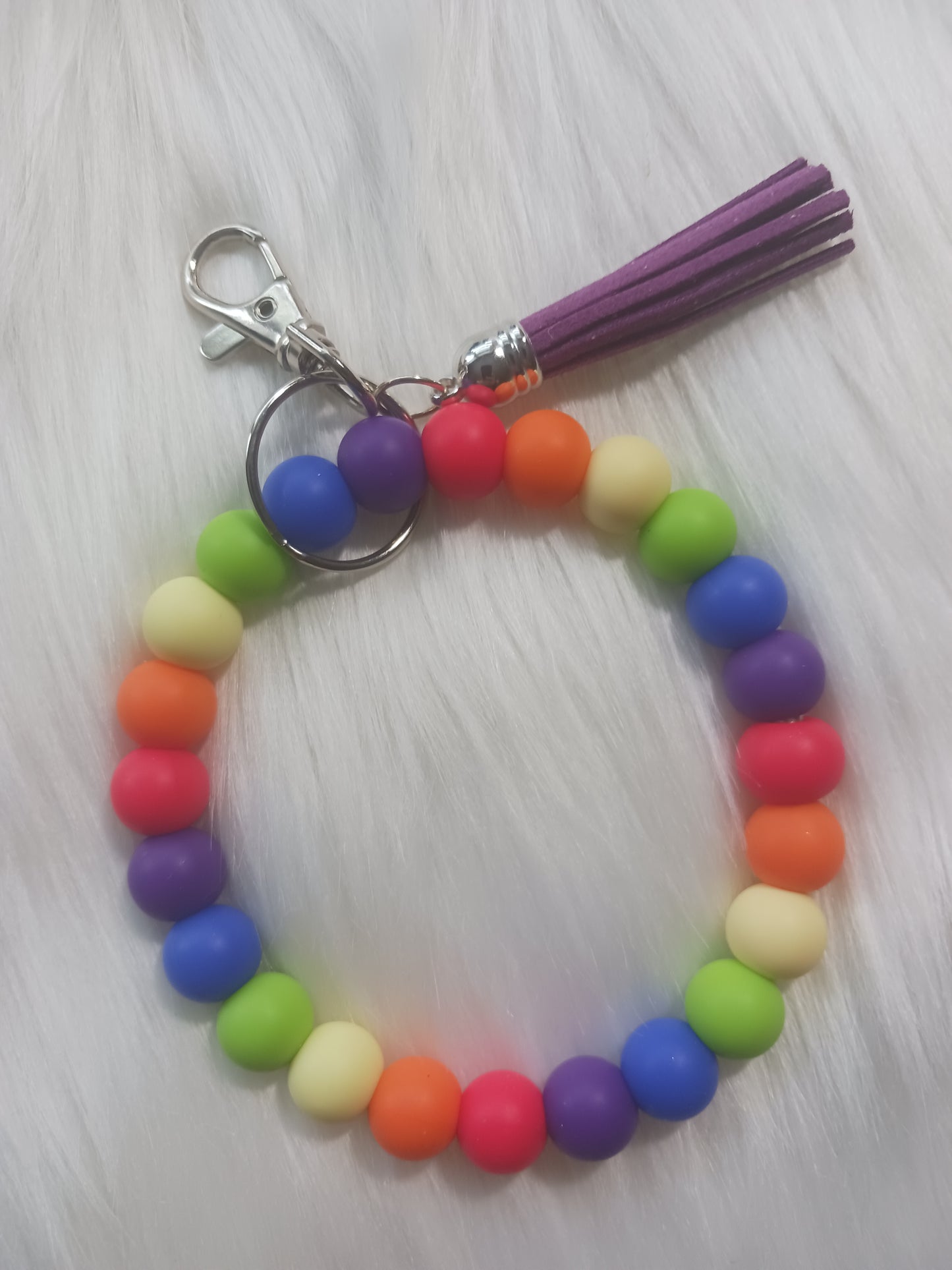 Rainbow colored silicone beaded wristlet with tassel